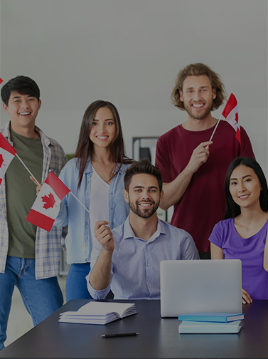 Multiracial group of people smiling and waving Canadian flags.