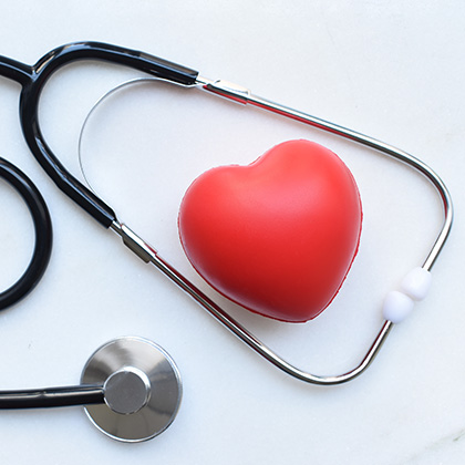 heart-shaped object inside stethoscope on table