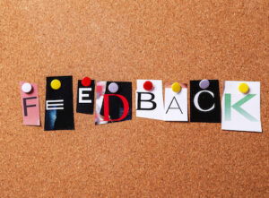 the word feedback spelled out in cutout letters on pegboard