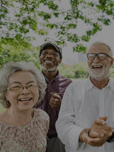 Three seniors outdoors under a tree